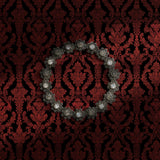 Dark and moody black and red damask wallpaper.