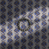 Vintage blue striped floral wallpaper on a light neutral background.