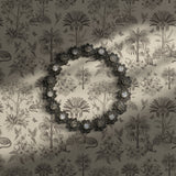 Cream and brown toile wallpaper featuring palm trees and jungle motifs.