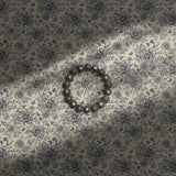 Feminine cream and blue floral wallpaper with birds, berries, and butterflies.