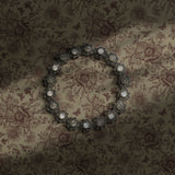 Moody beige brown floral wallpaper with birds, berries, and butterflies.