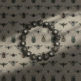 Vintage insect wallpaper on a cream background.